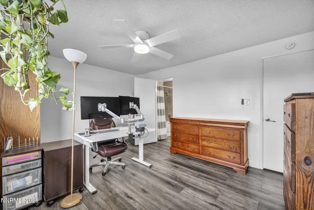 a workspace with furniture wooden floor and window