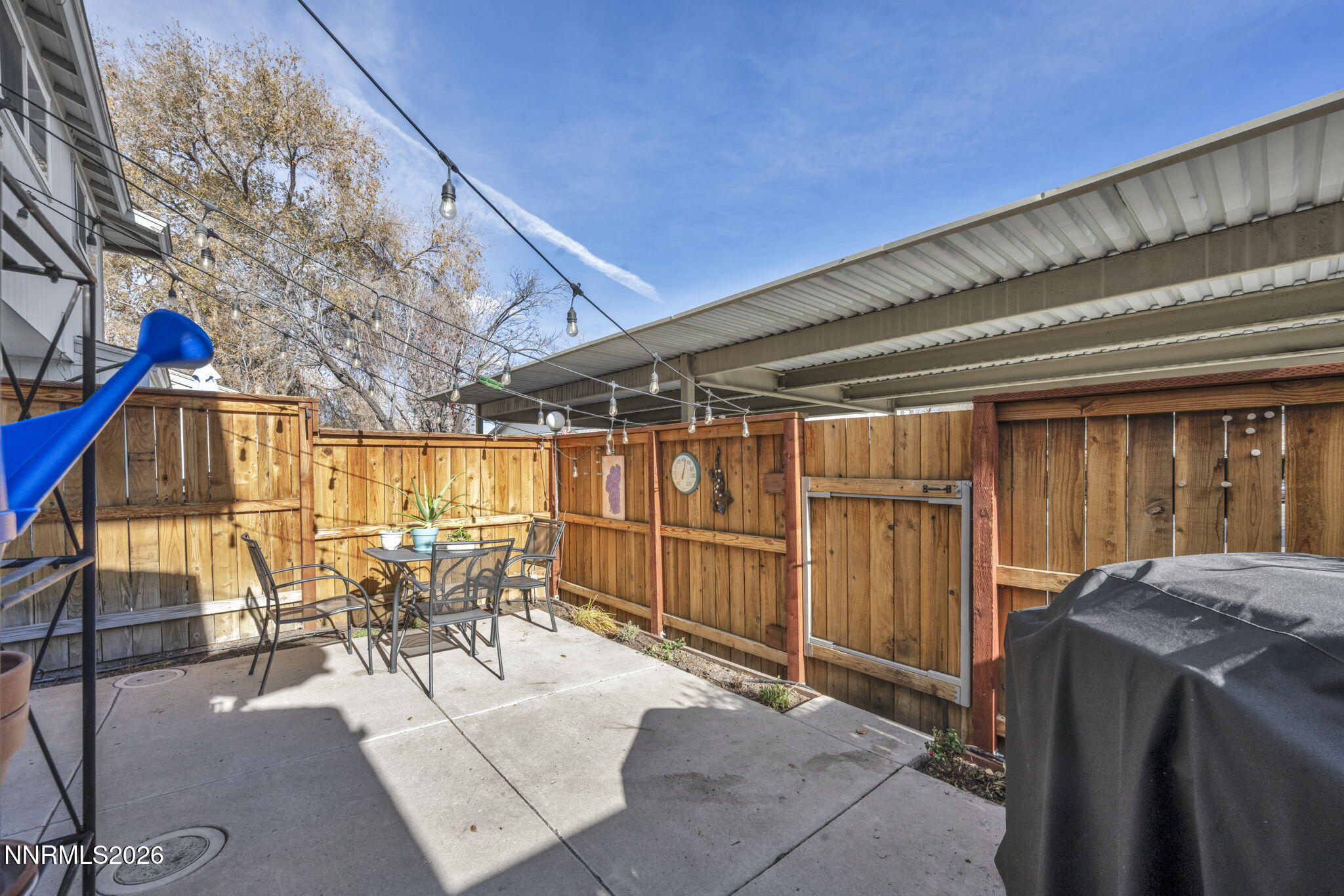 959 Mesa Ridge Drive, Unit 2 Sparks, NV 89434 - Photo 33 of 41 a view of a chairs and table in patio with wooden fence