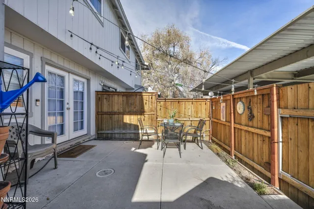 a view of a patio with table and chairs