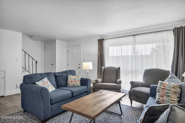 a living room with furniture and a large window