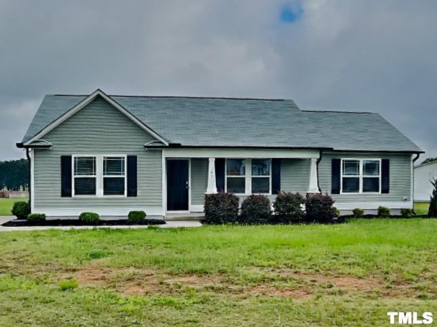 a front view of a house with garden and porch