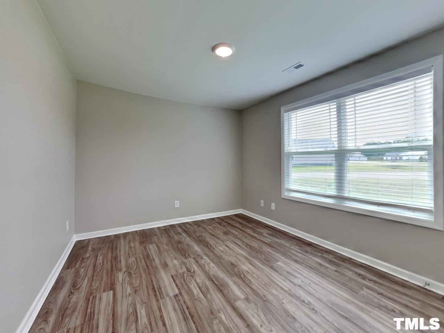 142 Beaver Tavern Drive Benson, NC 27504 - Photo 14 of 16 a view of a room with wooden floor and windows