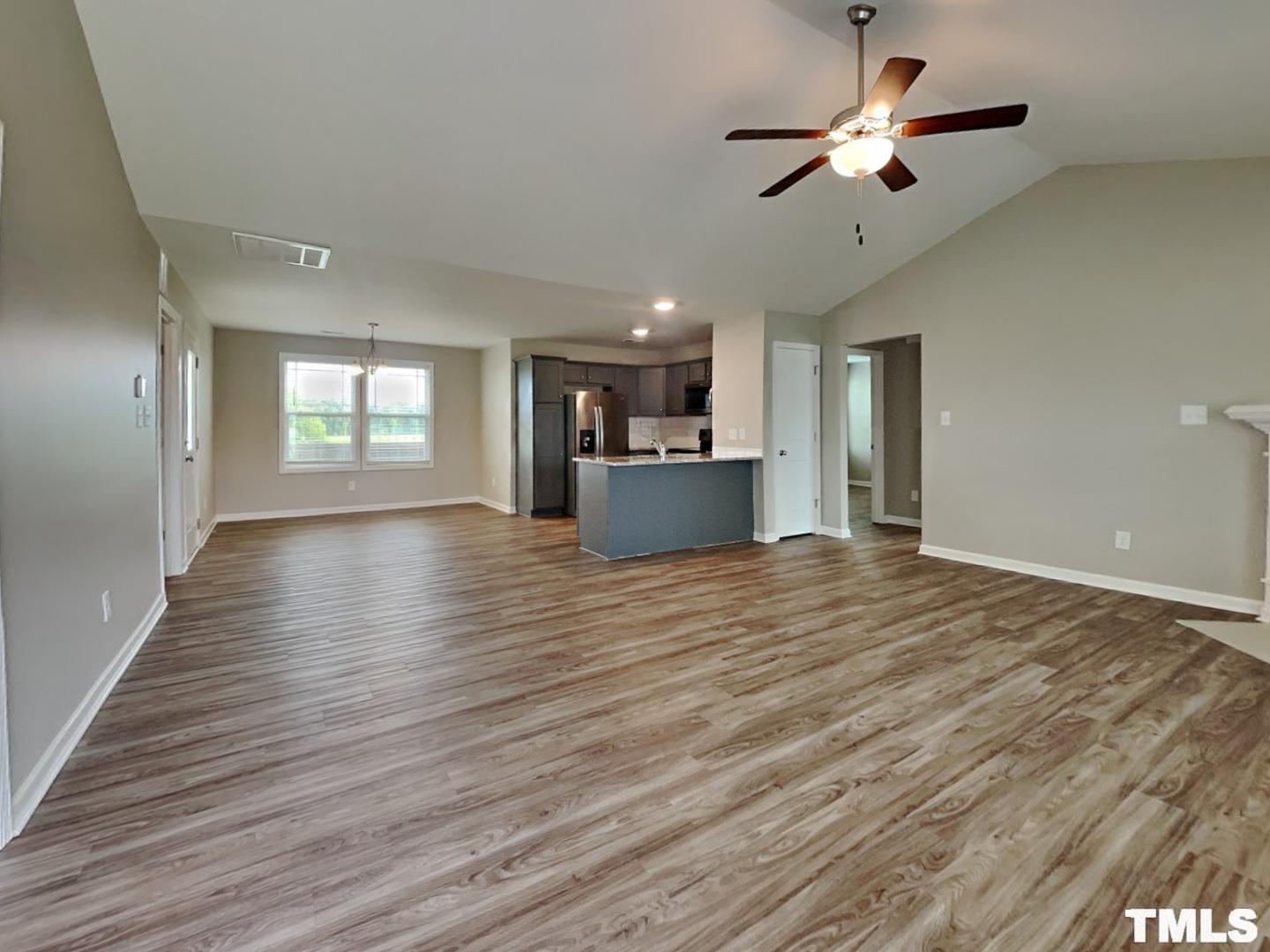 142 Beaver Tavern Drive Benson, NC 27504 - Photo 2 of 16 a view of an empty room with window and wooden floor