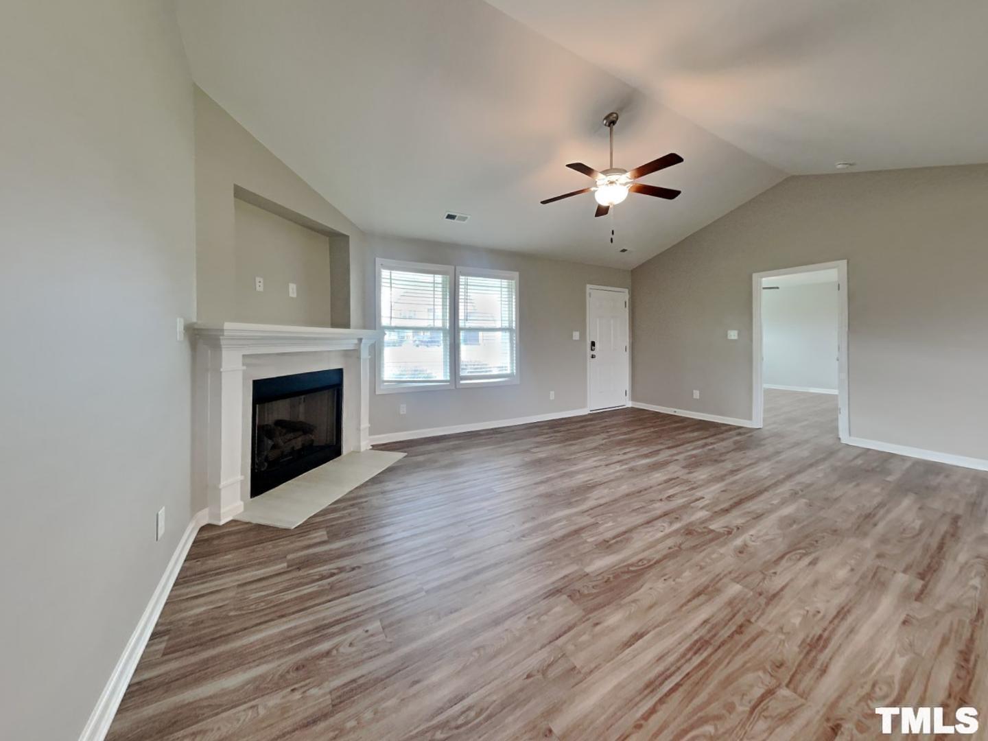 142 Beaver Tavern Drive Benson, NC 27504 - Photo 3 of 16 a view of empty room with wooden floor and fan