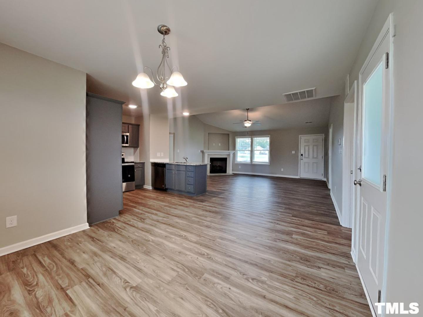 142 Beaver Tavern Drive Benson, NC 27504 - Photo 6 of 16 a view of a room with wooden floor and kitchen view