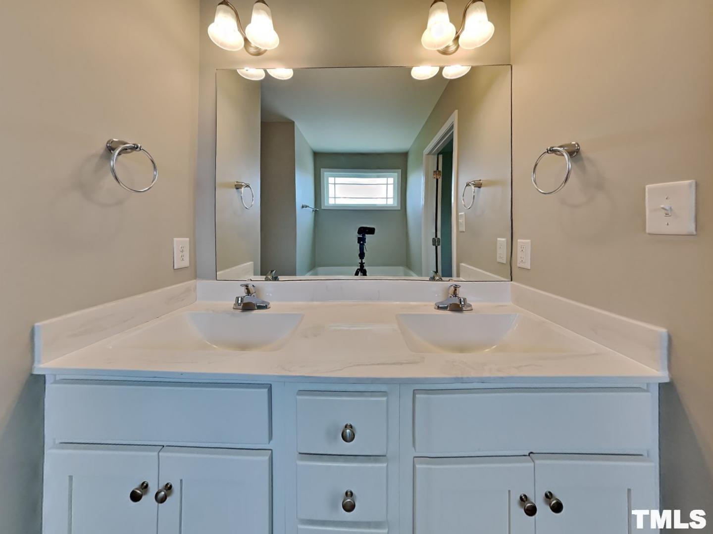 142 Beaver Tavern Drive Benson, NC 27504 - Photo 8 of 16 a bathroom with a sink vanity and a mirror