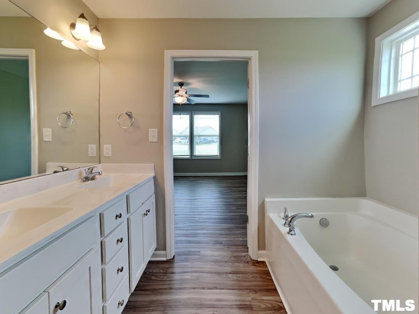 142 Beaver Tavern Drive Benson, NC 27504 - Photo 10 of 16 a bathroom with a tub sink and mirror