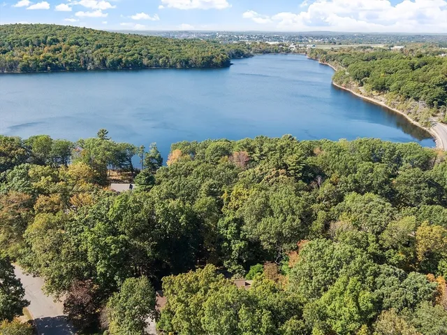 an aerial view of a houses with a lake view
