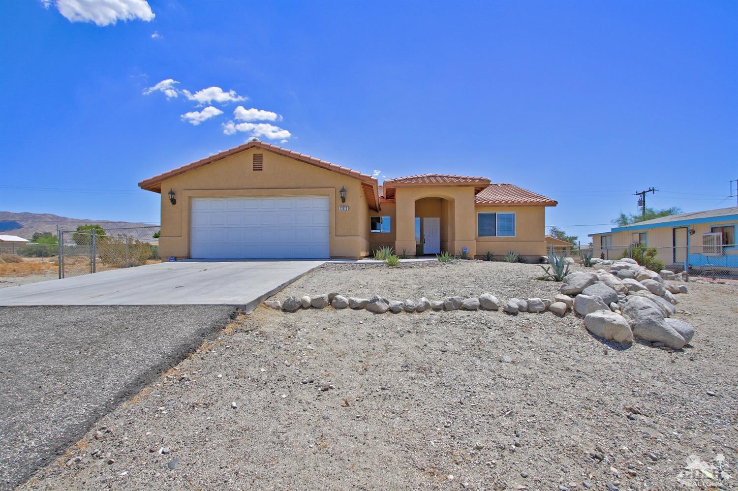 13810 United Road Desert Hot Springs, CA 92240 - Photo 1 of 41 a front view of a house with a yard