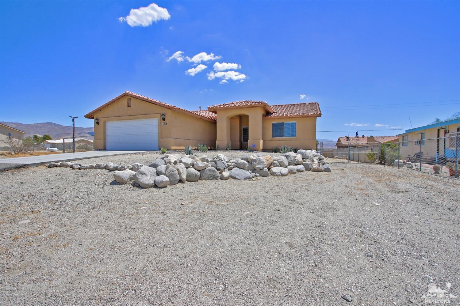 13810 United Road Desert Hot Springs, CA 92240 - Photo 2 of 41 a view of a house with a yard