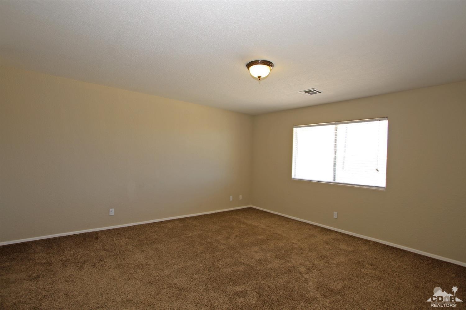 13810 United Road Desert Hot Springs, CA 92240 - Photo 15 of 41 an empty room with a window