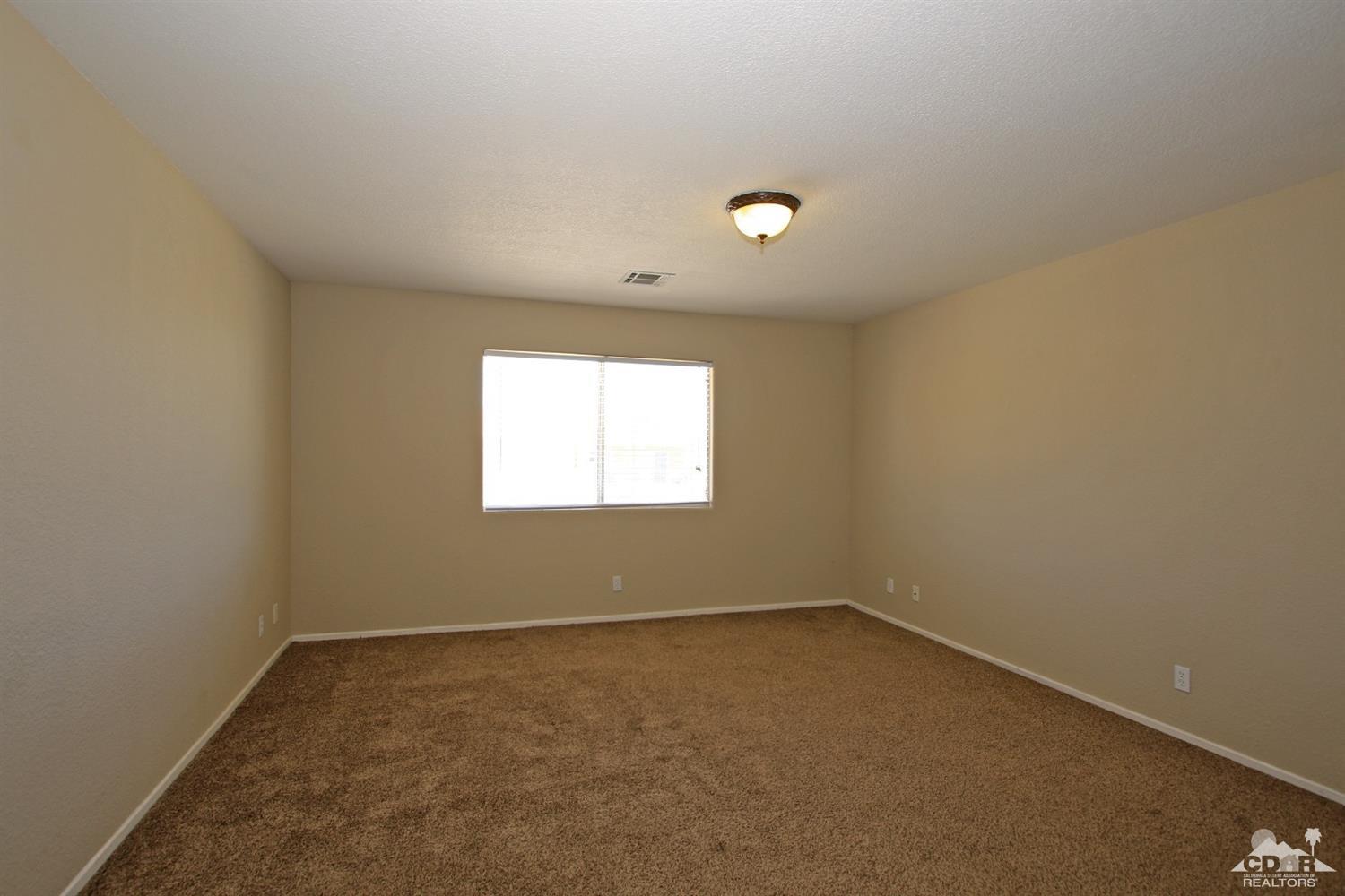 13810 United Road Desert Hot Springs, CA 92240 - Photo 18 of 41 an empty room with a window