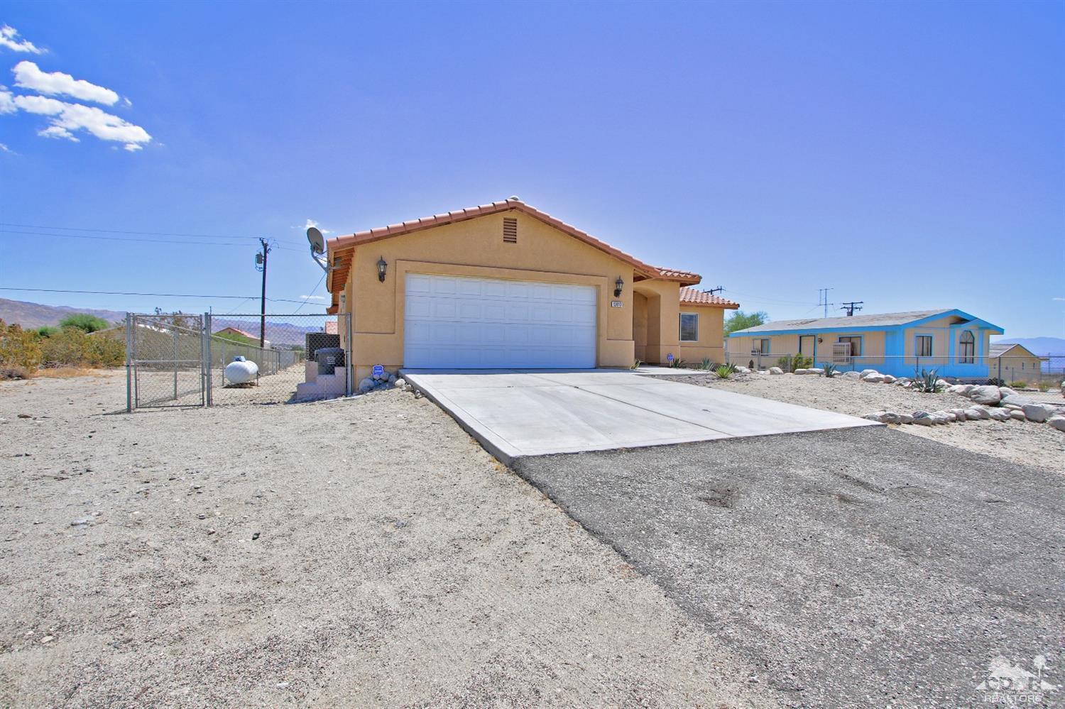 13810 United Road Desert Hot Springs, CA 92240 - Photo 3 of 41 a front view of a house with a yard
