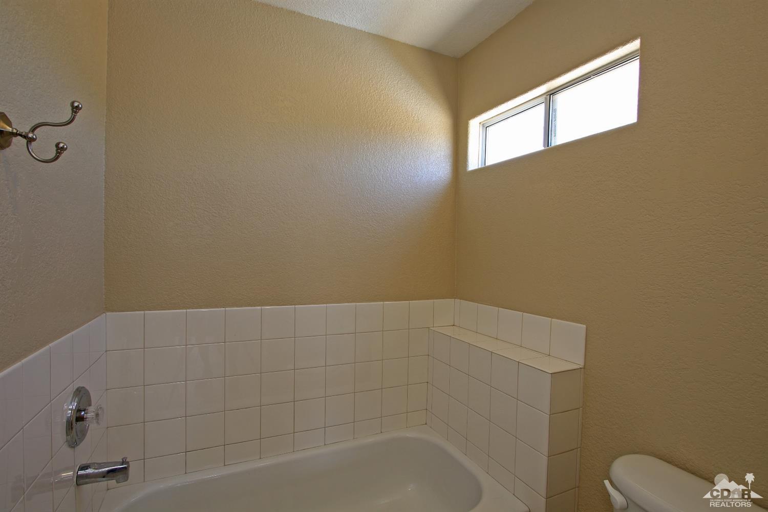 13810 United Road Desert Hot Springs, CA 92240 - Photo 21 of 41 a bathroom with a shower and toilet