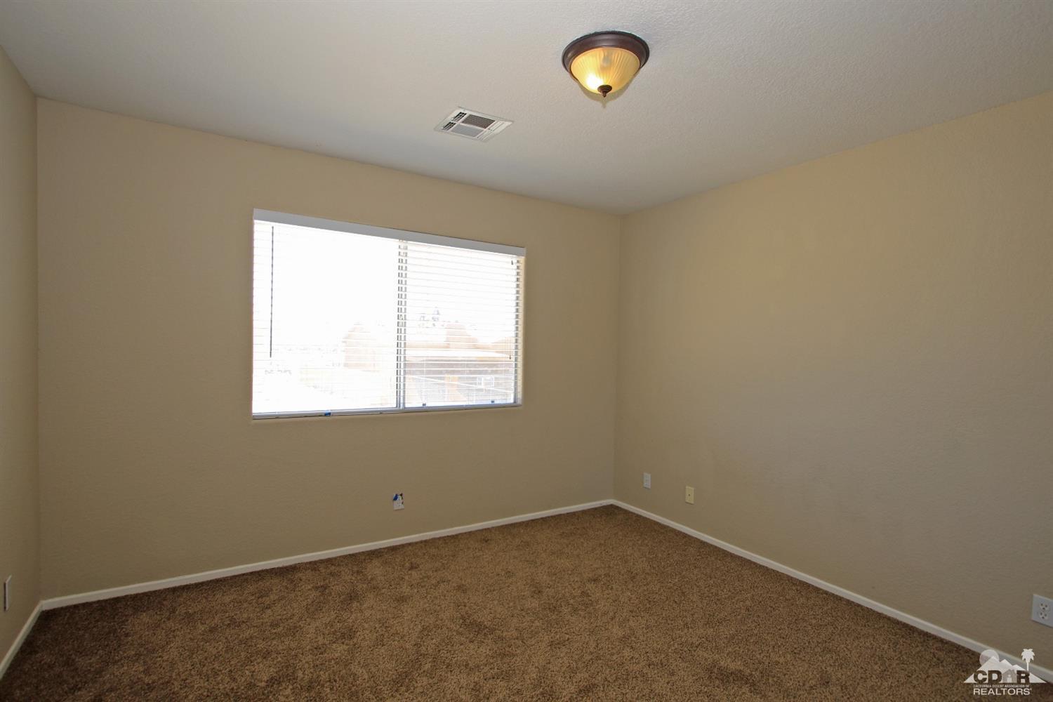 13810 United Road Desert Hot Springs, CA 92240 - Photo 22 of 41 an empty room with a window