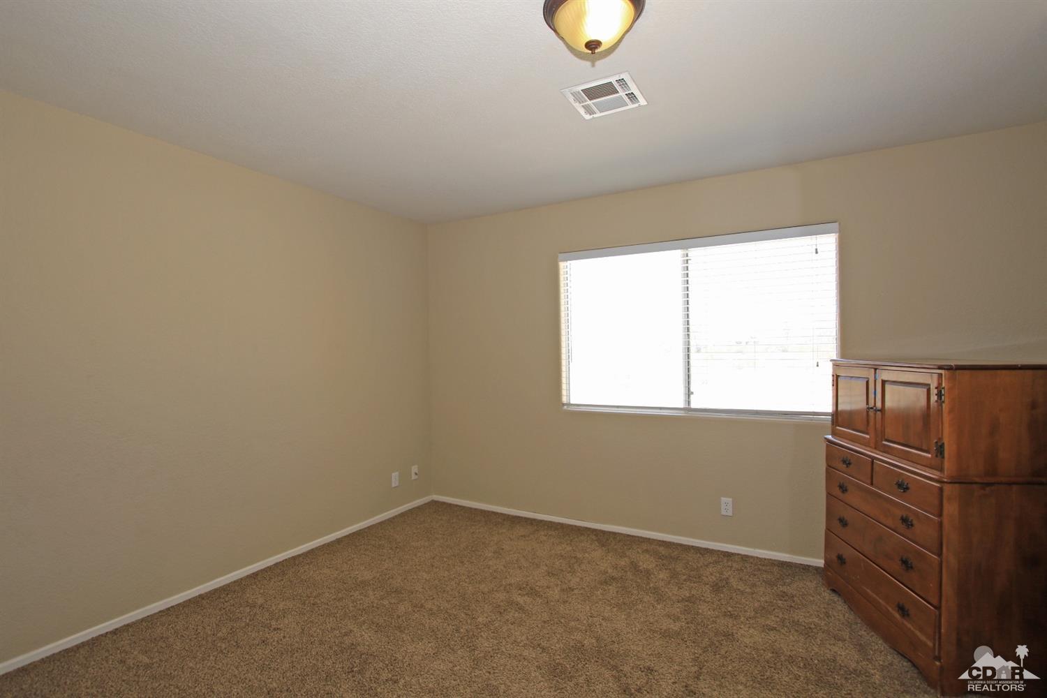 13810 United Road Desert Hot Springs, CA 92240 - Photo 24 of 41 an empty room with windows
