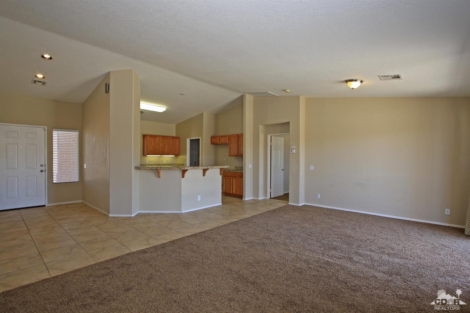 13810 United Road Desert Hot Springs, CA 92240 - Photo 4 of 41 a view of a kitchen with a refrigerator