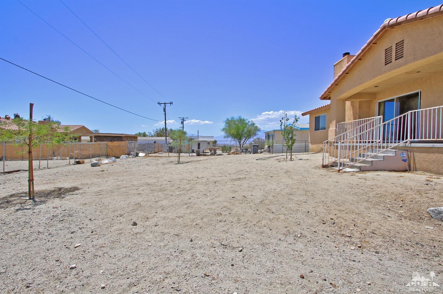 13810 United Road Desert Hot Springs, CA 92240 - Photo 31 of 41 a street view with large trees