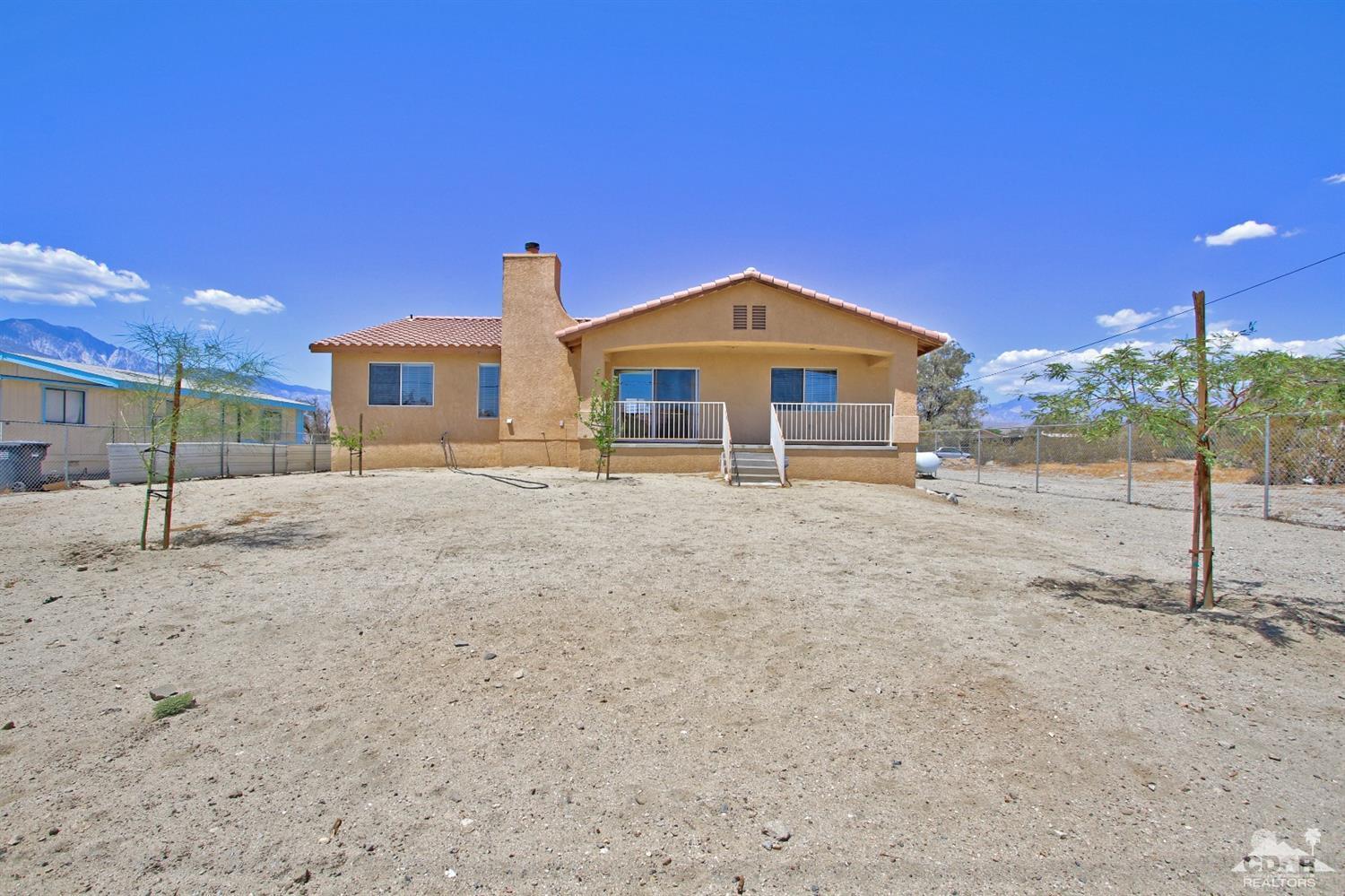 13810 United Road Desert Hot Springs, CA 92240 - Photo 34 of 41 a front view of a house with a yard