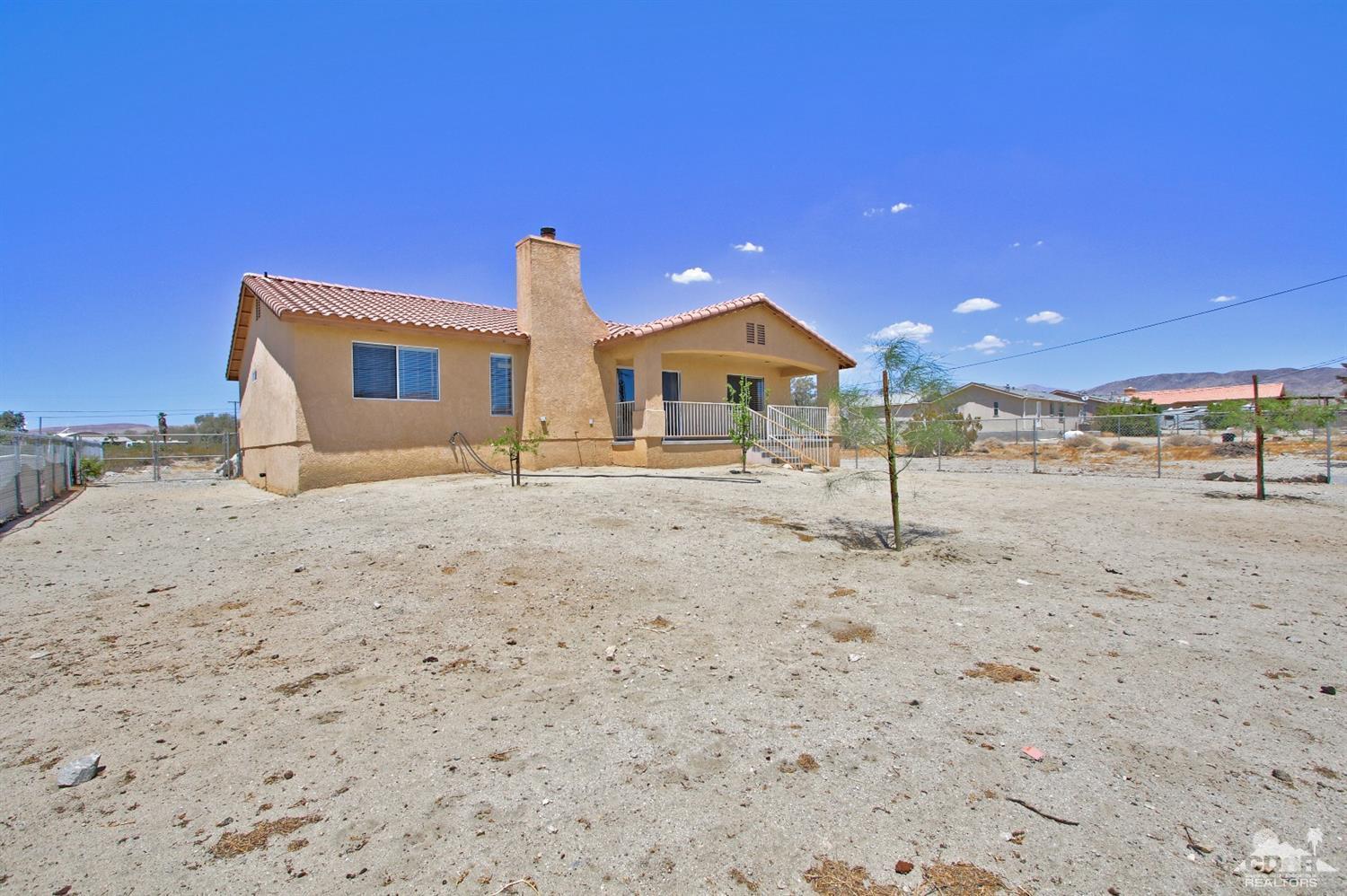 13810 United Road Desert Hot Springs, CA 92240 - Photo 35 of 41 a front view of a house with a yard
