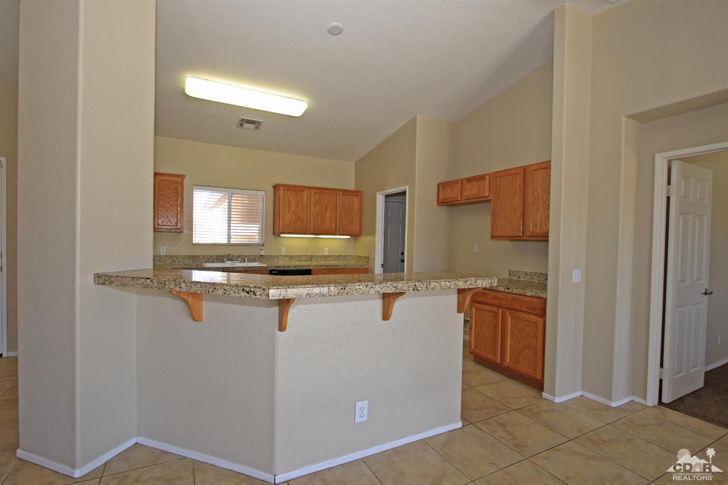 13810 United Road Desert Hot Springs, CA 92240 - Photo 6 of 41 a kitchen with stainless steel appliances granite countertop a sink and cabinets