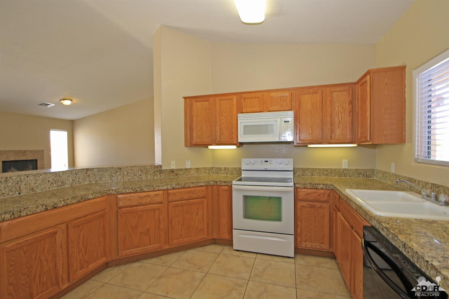 13810 United Road Desert Hot Springs, CA 92240 - Photo 8 of 41 a kitchen with a sink stove and cabinets