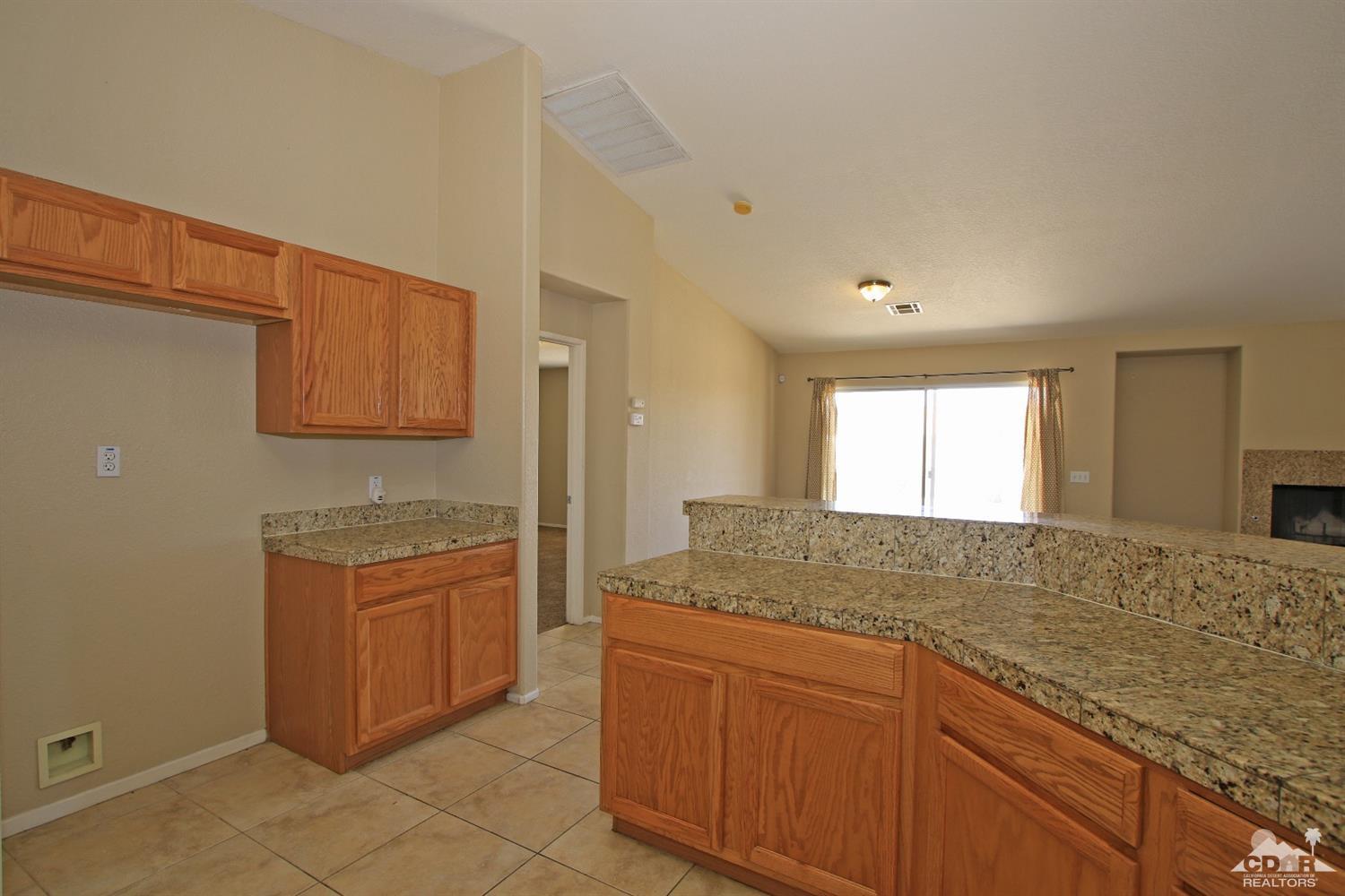13810 United Road Desert Hot Springs, CA 92240 - Photo 9 of 41 a bathroom with a granite countertop sink and a mirror