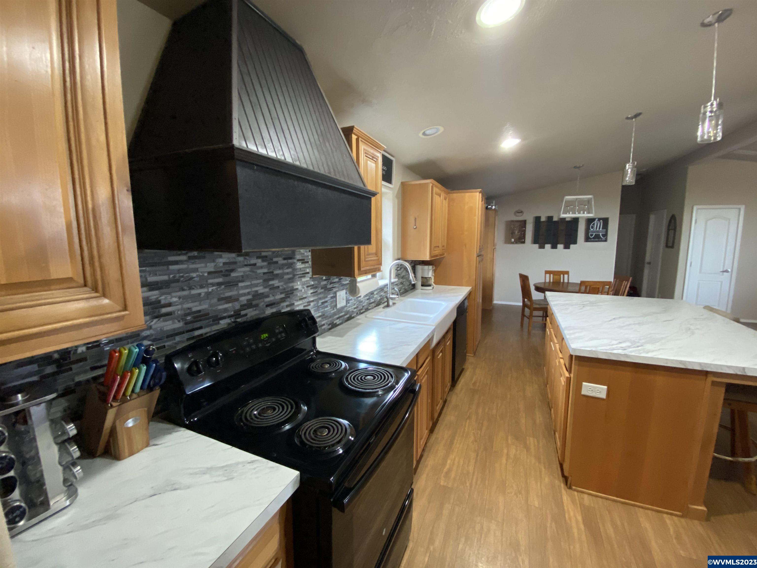 6120 Little Road Southeast Turner, OR 97392 - Photo 7 of 21 a kitchen with a stove and a refrigerator