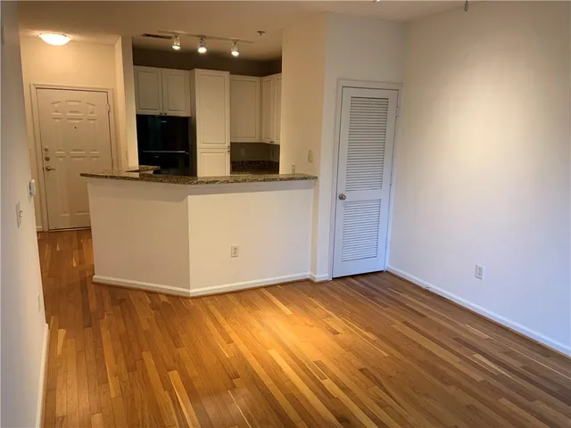 a view of kitchen with wooden floor and electronic appliances