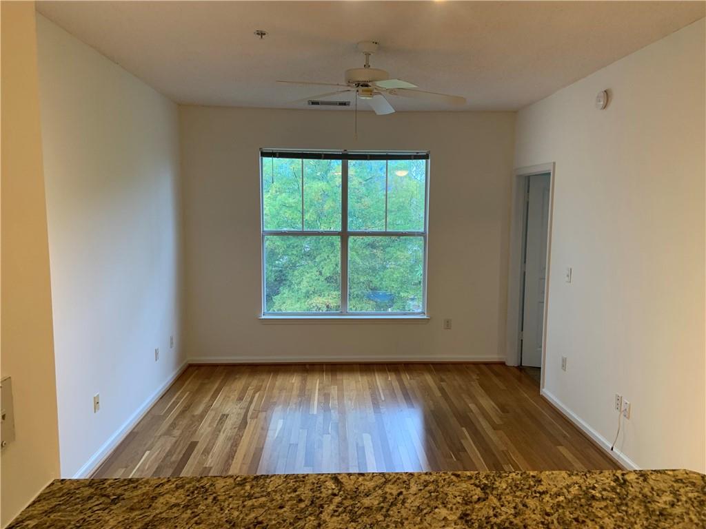 10 Perimeter Summit Boulevard, Unit 1404 Brookhaven, GA 30319 - Photo 11 of 39 wooden floor in an empty room with a window