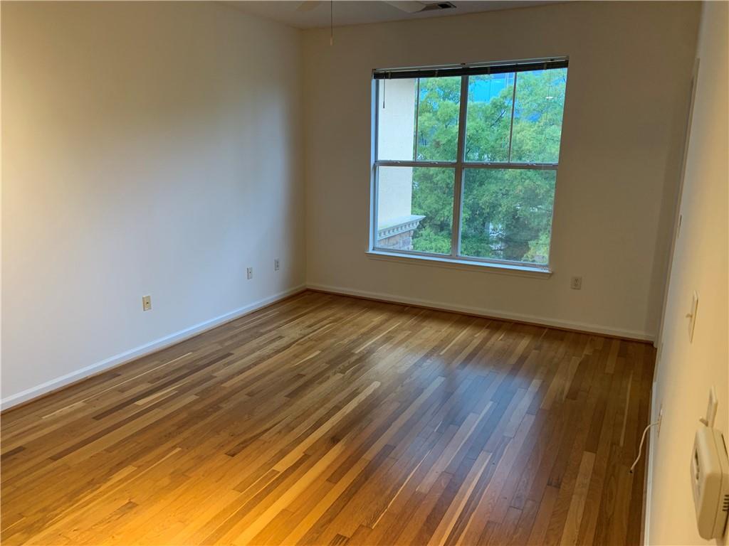 10 Perimeter Summit Boulevard, Unit 1404 Brookhaven, GA 30319 - Photo 12 of 39 a view of an empty room with wooden floor and a window