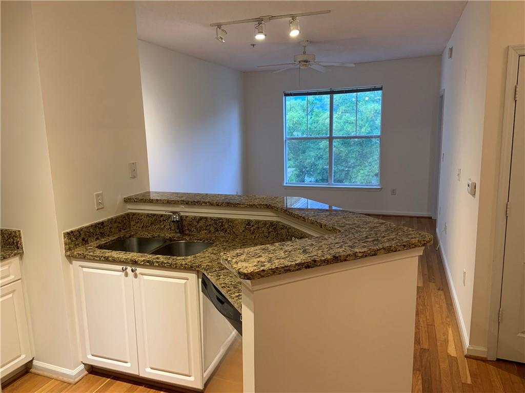 10 Perimeter Summit Boulevard, Unit 1404 Brookhaven, GA 30319 - Photo 8 of 39 a view of kitchen island a sink wooden floor and a window