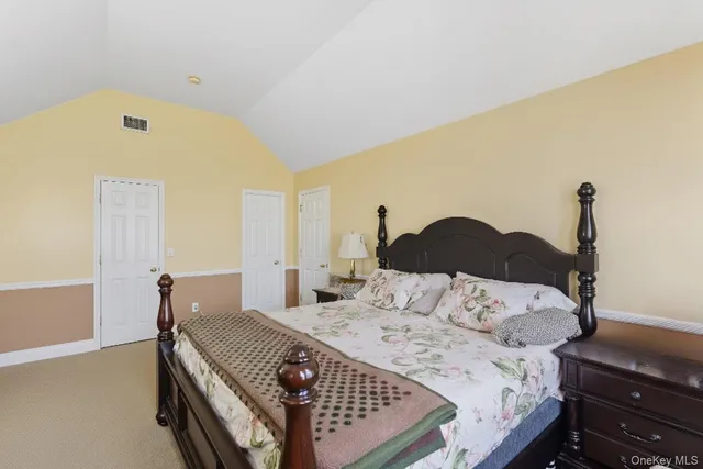 a bedroom with a bed and a lamp with window