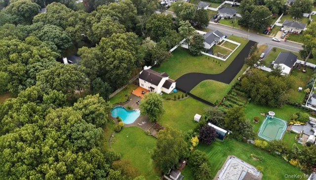 an aerial view of a house with yard swimming pool and outdoor seating