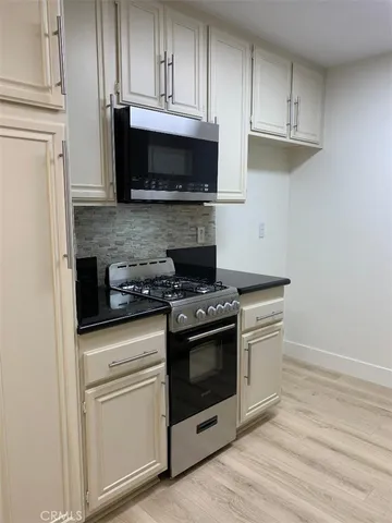 a close view of a sink and dishwasher with kitchen island