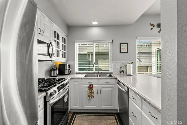 a kitchen that has a sink and a stove