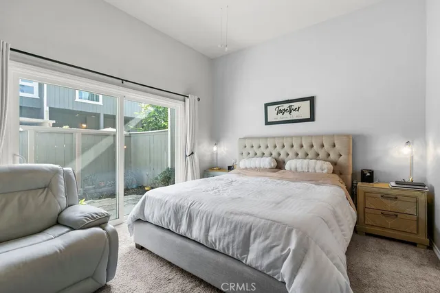 a bedroom with a bed and glass window