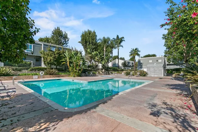 a view of a swimming pool with outdoor seating