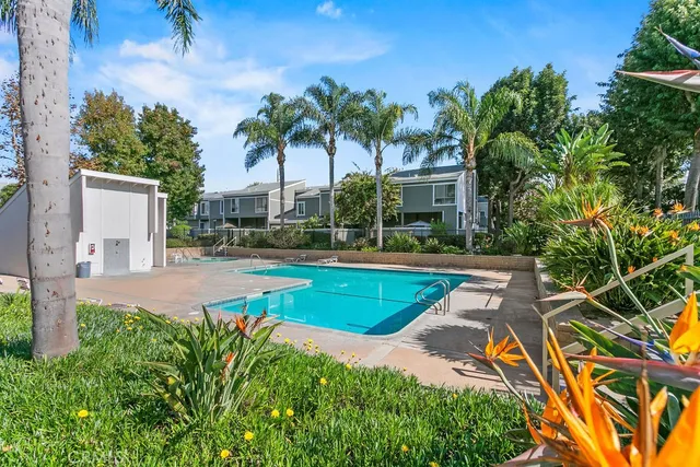 a view of a house with swimming pool and sitting area