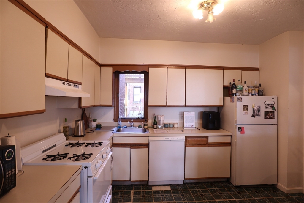 7 Saybrook Street, Unit 17 Boston, MA 02135 - Photo 12 of 30 a kitchen that has a lot of cabinets in it and appliances
