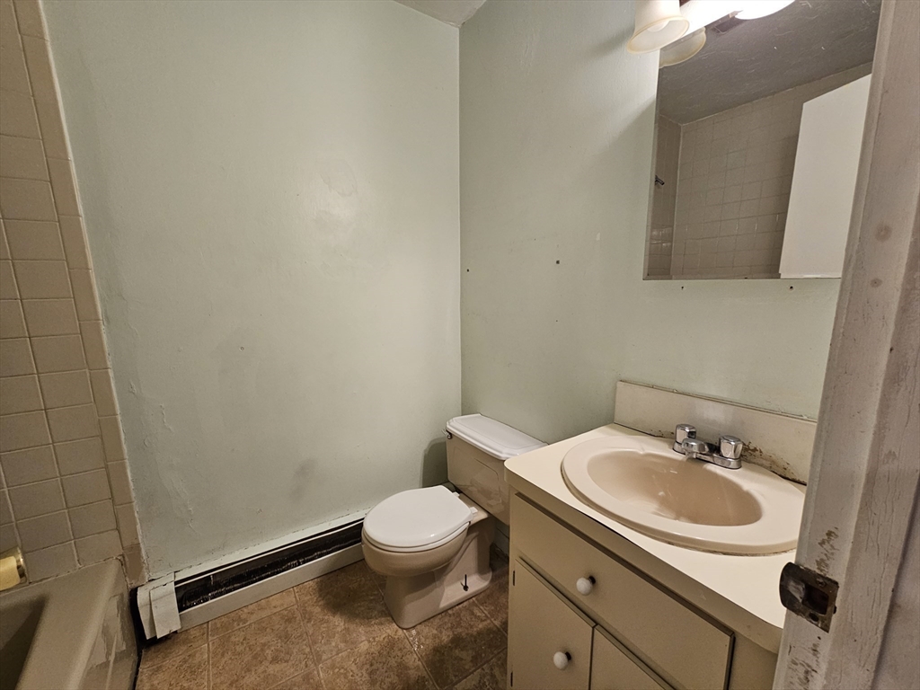 7 Saybrook Street, Unit 17 Boston, MA 02135 - Photo 18 of 30 a bathroom with a sink toilet and mirror