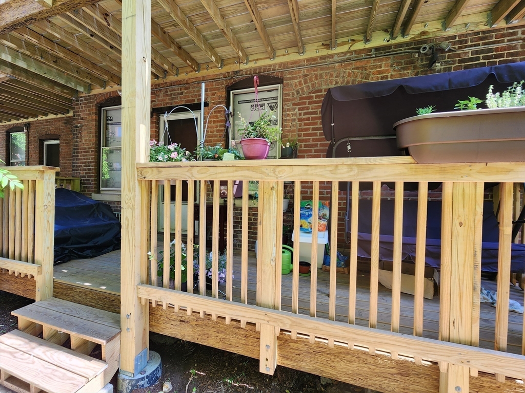 7 Saybrook Street, Unit 17 Boston, MA 02135 - Photo 19 of 30 a view of a deck with a table and chairs