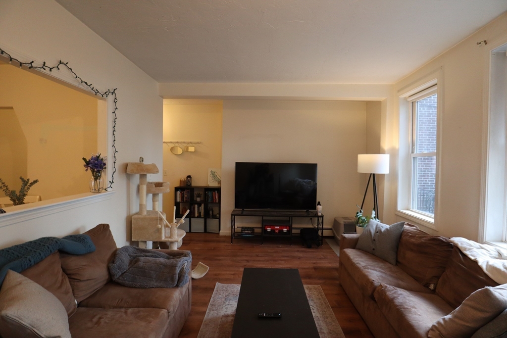 7 Saybrook Street, Unit 17 Boston, MA 02135 - Photo 2 of 30 a living room with furniture and a flat screen tv