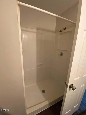 a bathroom with a glass shower door