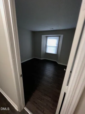 a view of an empty room and wooden floor