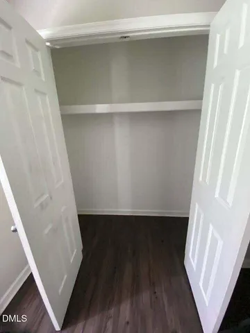 a view of walk in closet with wooden floor