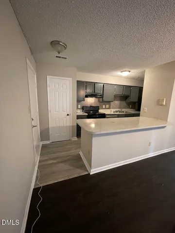 a kitchen with a sink stainless steel appliances and cabinets