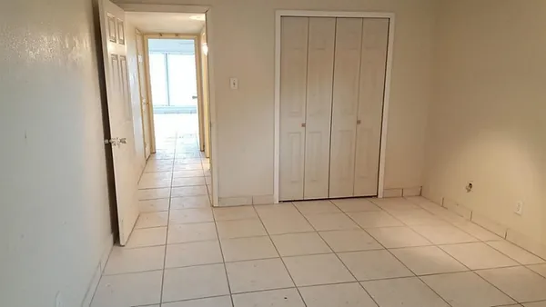 an empty room with cabinet in front door
