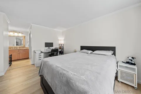 a spacious bedroom with a bed and a dresser in it