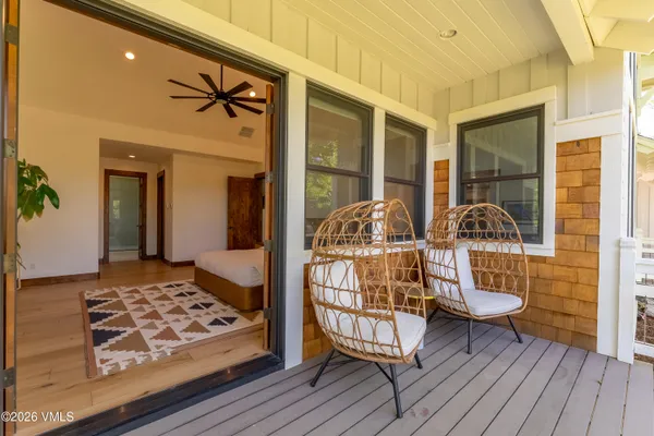 a bedroom with a bed and a wooden floor